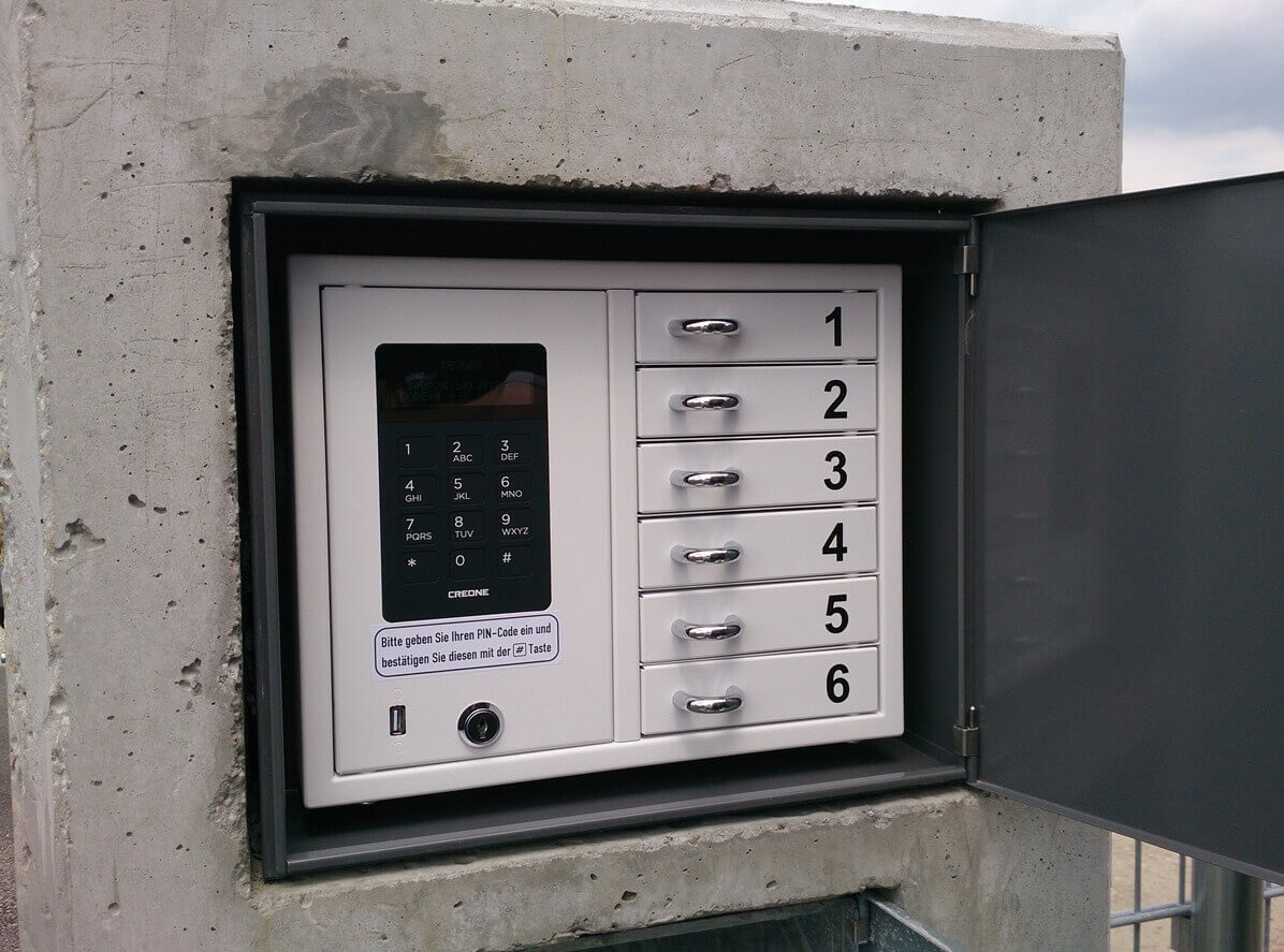 Elektronisches Schließfachsystem mit sechs nummerierten Fächern und PIN-Tastatur für sichere Übergabe von Schlüsseln oder Paketen